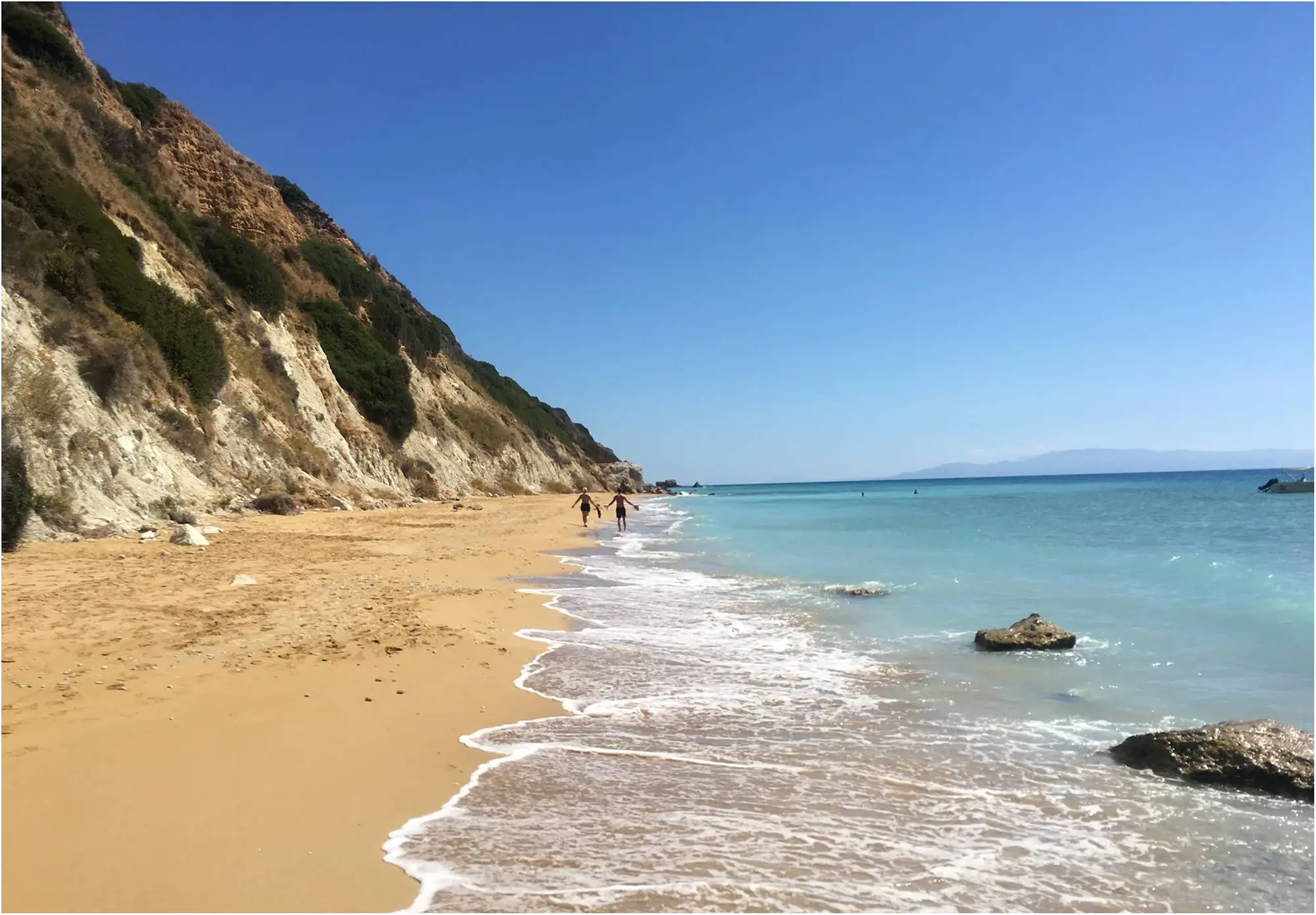 The golden sands of Koroni Beach, a popular swimming stop for boat rentals from Katelios