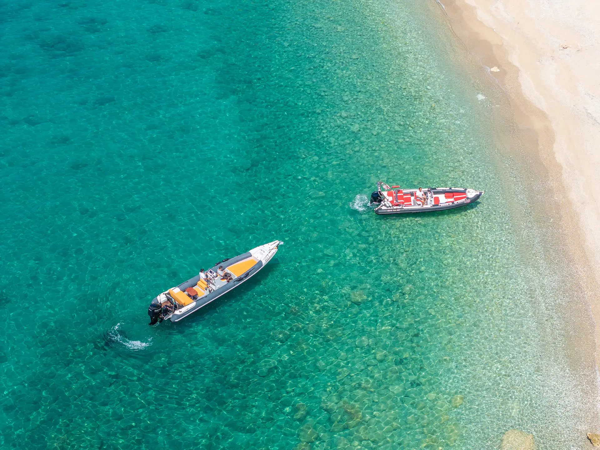 Approaching a hidden sandy cove for a swim stop with our premium rental boats from Katelios